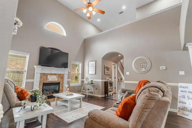 a living room with fireplace furniture and a flat screen tv