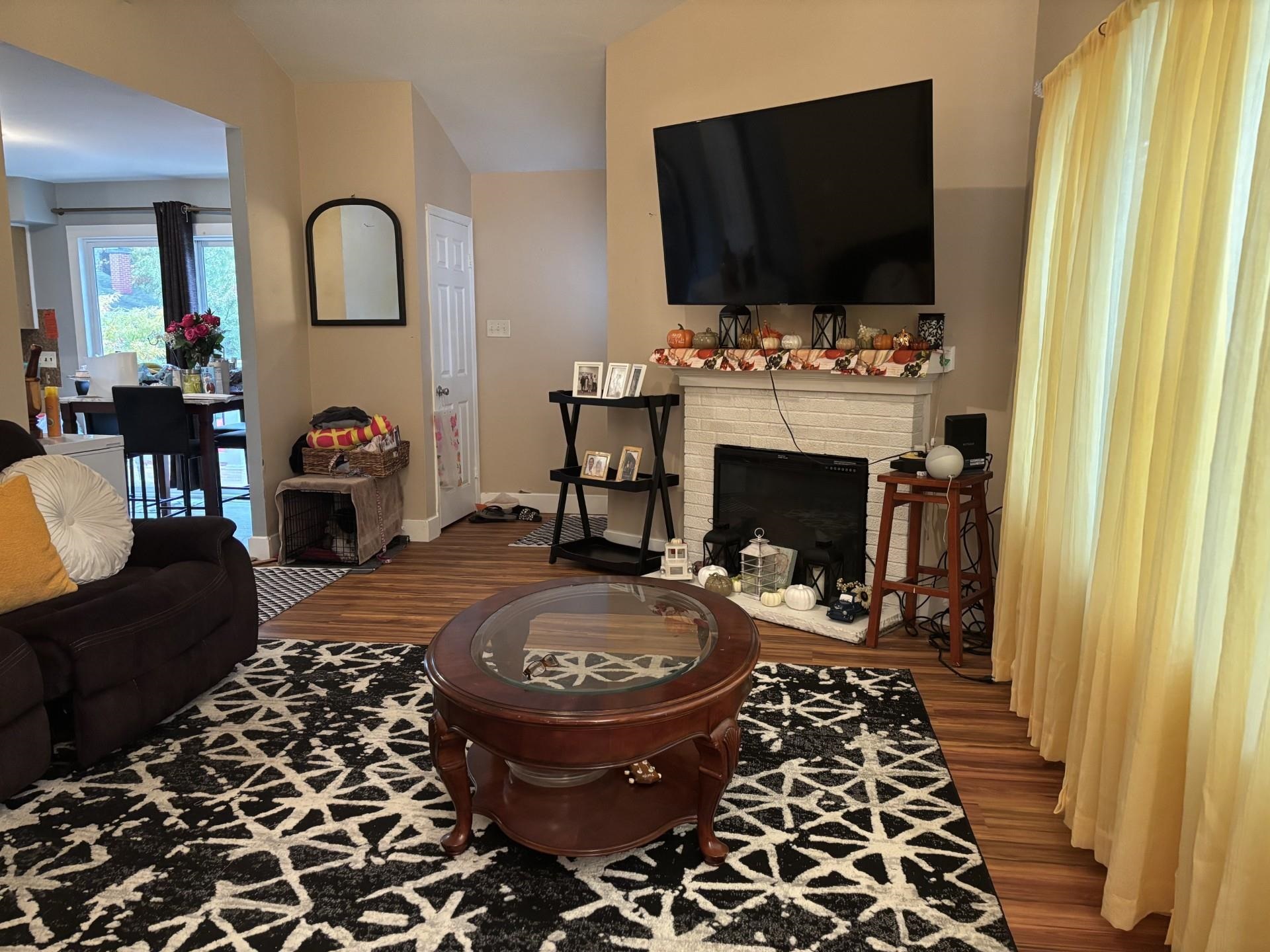 6 Hawthorne Drive Rio Grande, NJ 08242 - Photo 3 of 11 a living room with furniture a flat screen tv and a fireplace