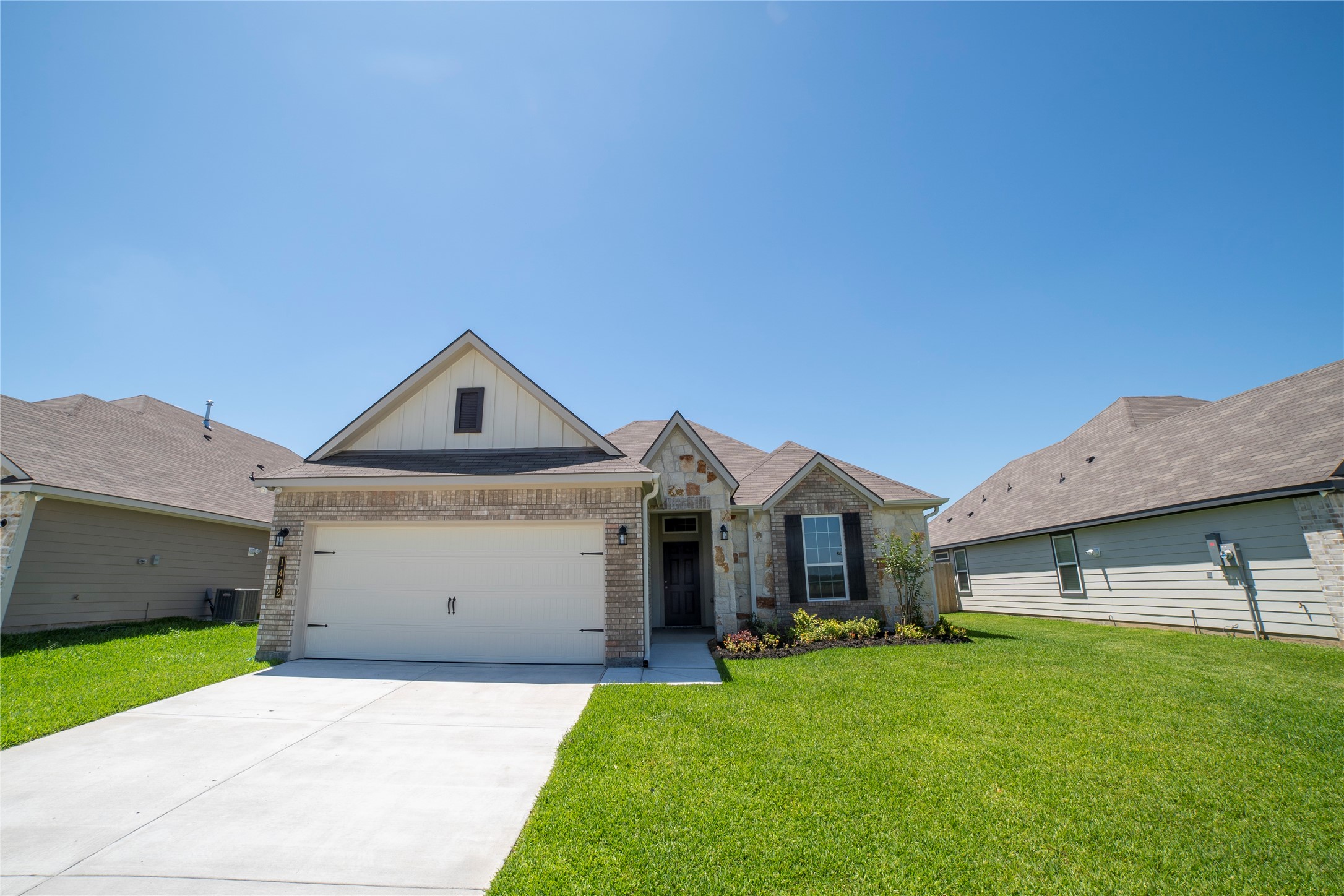 1402 Lk Rdg Drive Brenham, TX 77833 - Photo 2 of 35 a front view of a house with a yard and garage