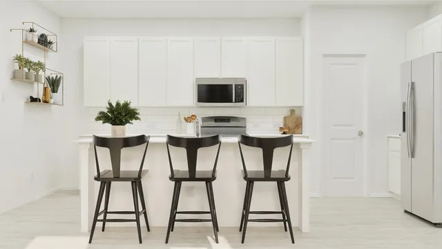 a kitchen with a table chairs a oven a stove a dining table and chairs
