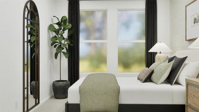 a bedroom with a bed and a potted plant