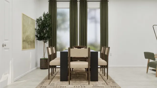 a view of a dining room with furniture and a potted plant