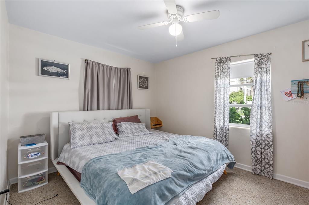 331 Hernando Street, Unit S 123 Fort Pierce, FL 34949 - Photo 14 of 52 a bedroom with a large bed and a chandelier
