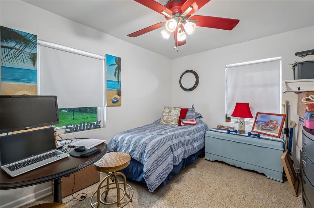 331 Hernando Street, Unit S 123 Fort Pierce, FL 34949 - Photo 19 of 52 a bedroom with a bed and dresser with wooden floor