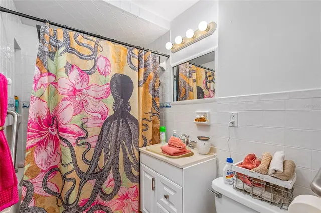 a living room with furniture a ceiling fan and a rug