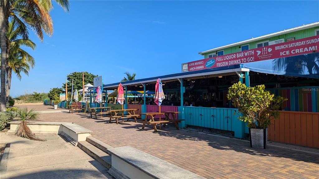 331 Hernando Street, Unit S 123 Fort Pierce, FL 34949 - Photo 51 of 52 a view of a patio with a table and chairs under an umbrella