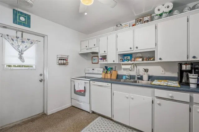 a white refrigerator freezer sitting inside of a kitchen