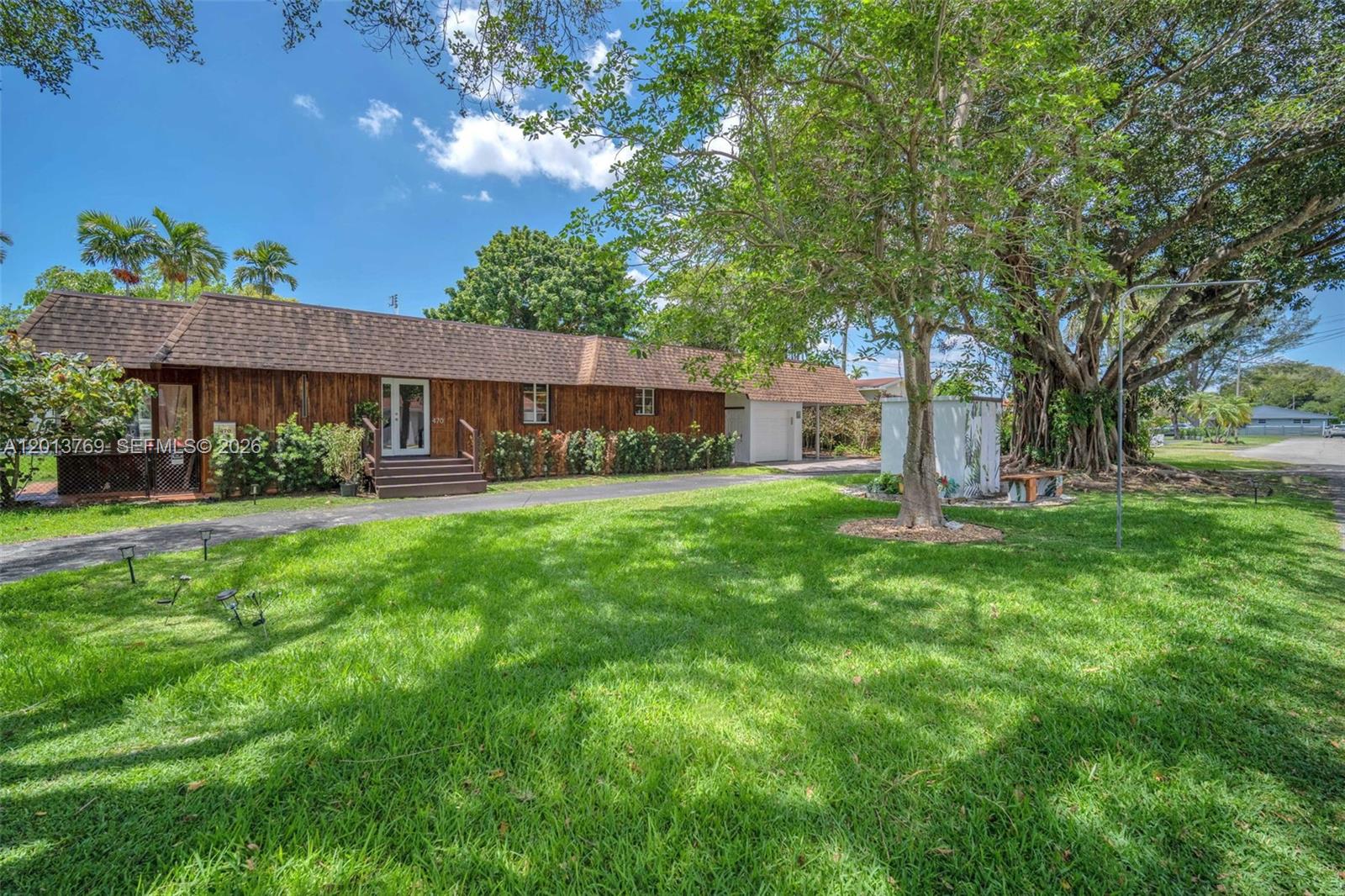 470 Northeast 113th Street, Unit 1 Miami, FL 33161 - Photo 1 of 56 a front view of a house with garden