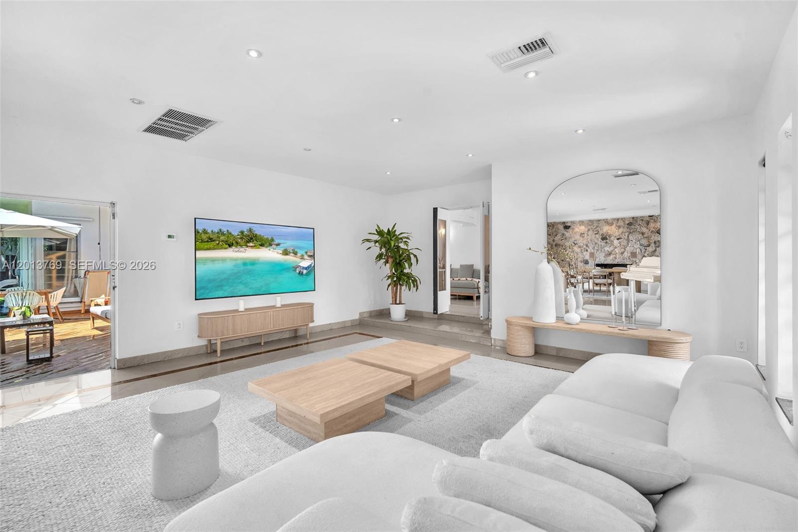 470 Northeast 113th Street, Unit 1 Miami, FL 33161 - Photo 21 of 56 a living room with furniture and a flat screen tv