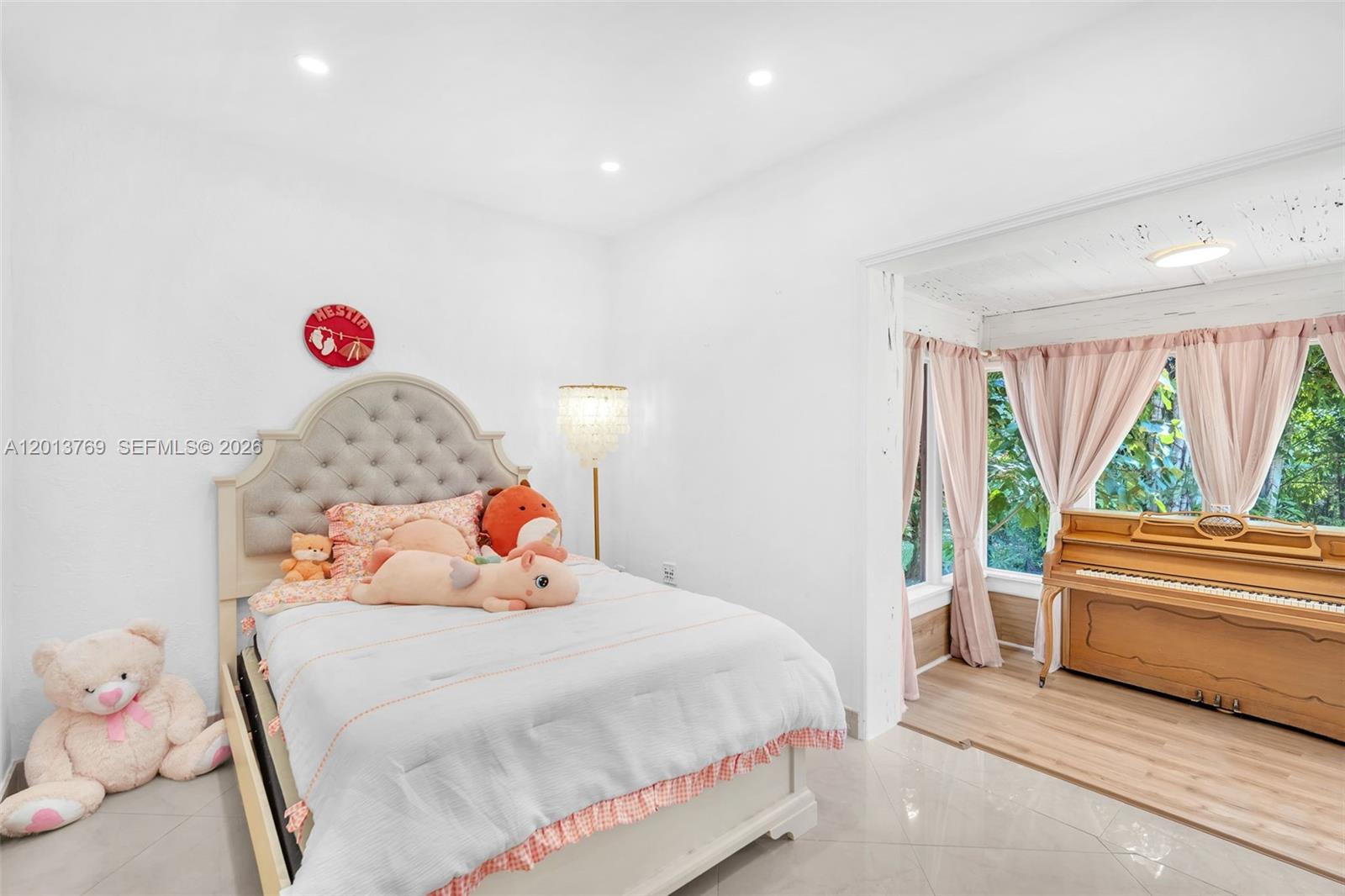 470 Northeast 113th Street, Unit 1 Miami, FL 33161 - Photo 24 of 56 a bedroom with a bed and a window