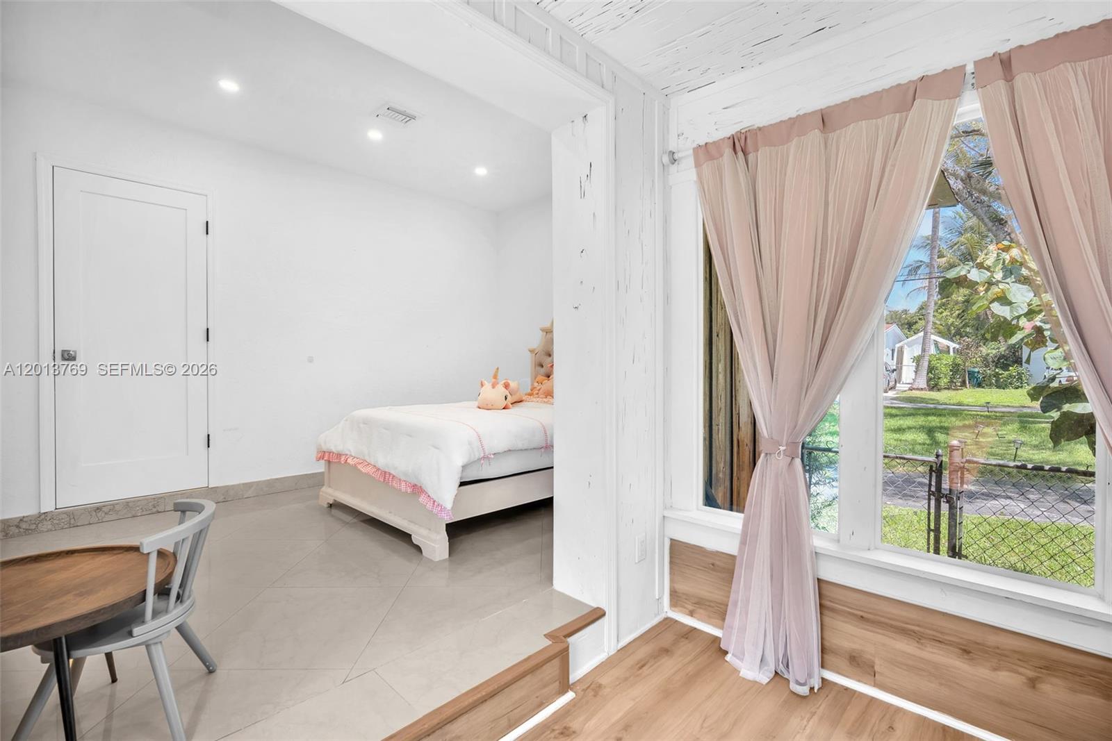 470 Northeast 113th Street, Unit 1 Miami, FL 33161 - Photo 26 of 56 a spacious bedroom with a bed and a window