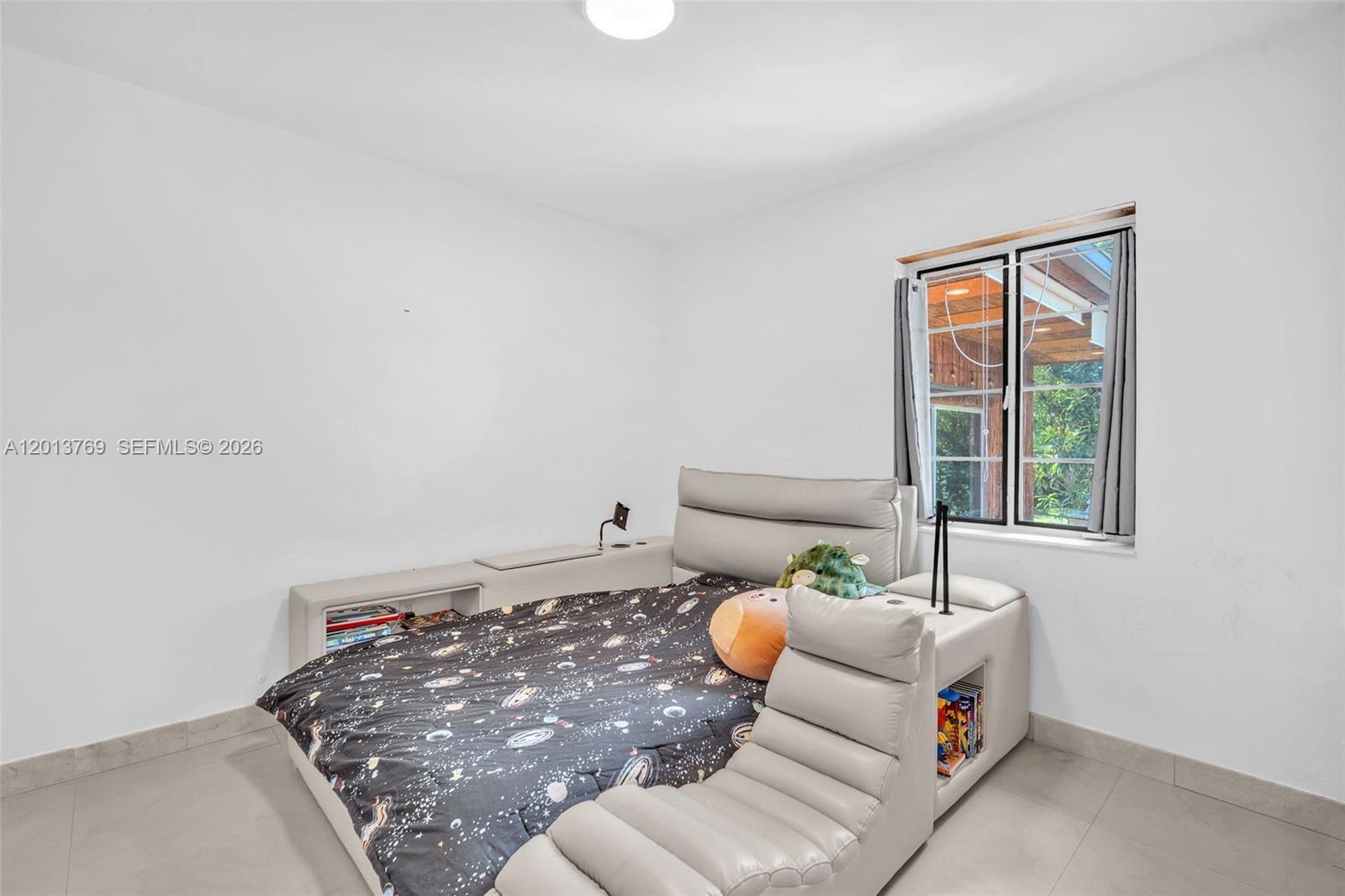 470 Northeast 113th Street, Unit 1 Miami, FL 33161 - Photo 27 of 56 a living room with furniture and a window