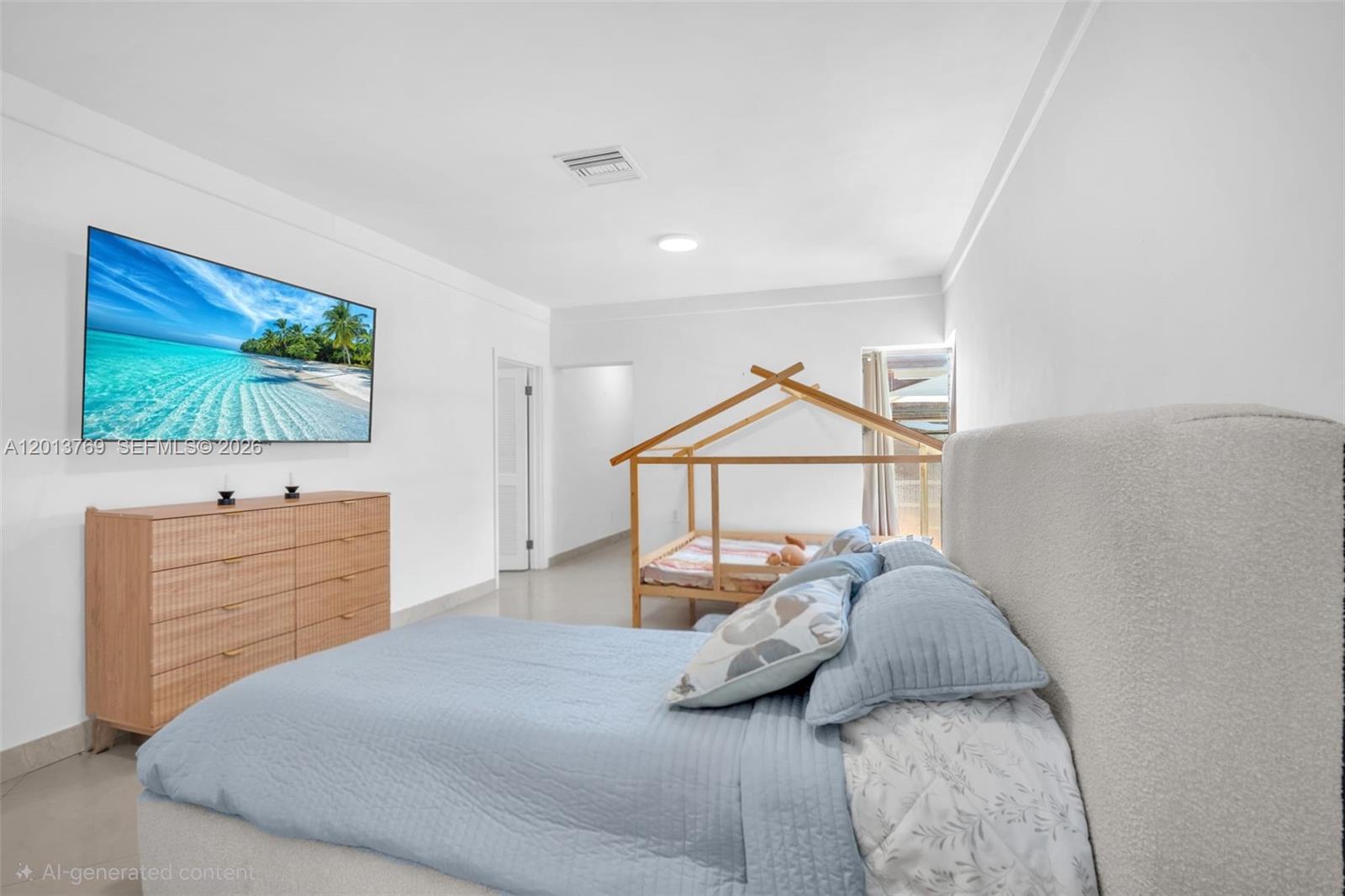 470 Northeast 113th Street, Unit 1 Miami, FL 33161 - Photo 29 of 56 a bedroom with a bed and a flat screen tv
