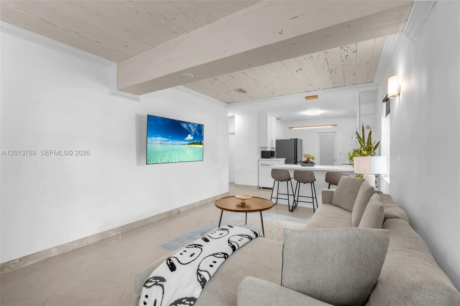 470 Northeast 113th Street, Unit 1 Miami, FL 33161 - Photo 3 of 56 a living room with furniture and a flat screen tv