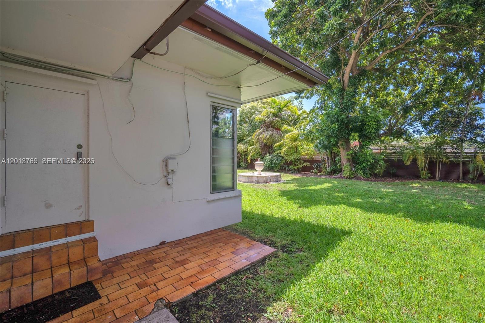 470 Northeast 113th Street, Unit 1 Miami, FL 33161 - Photo 33 of 56 a view of an house with backyard and a tree