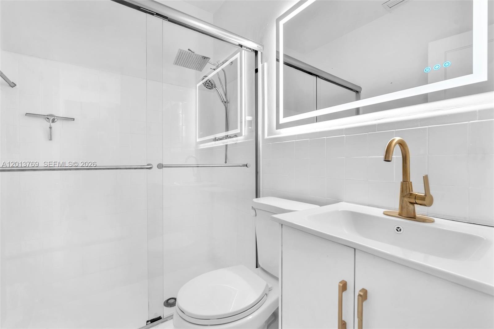 470 Northeast 113th Street, Unit 1 Miami, FL 33161 - Photo 39 of 56 a bathroom with a sink a toilet and shower