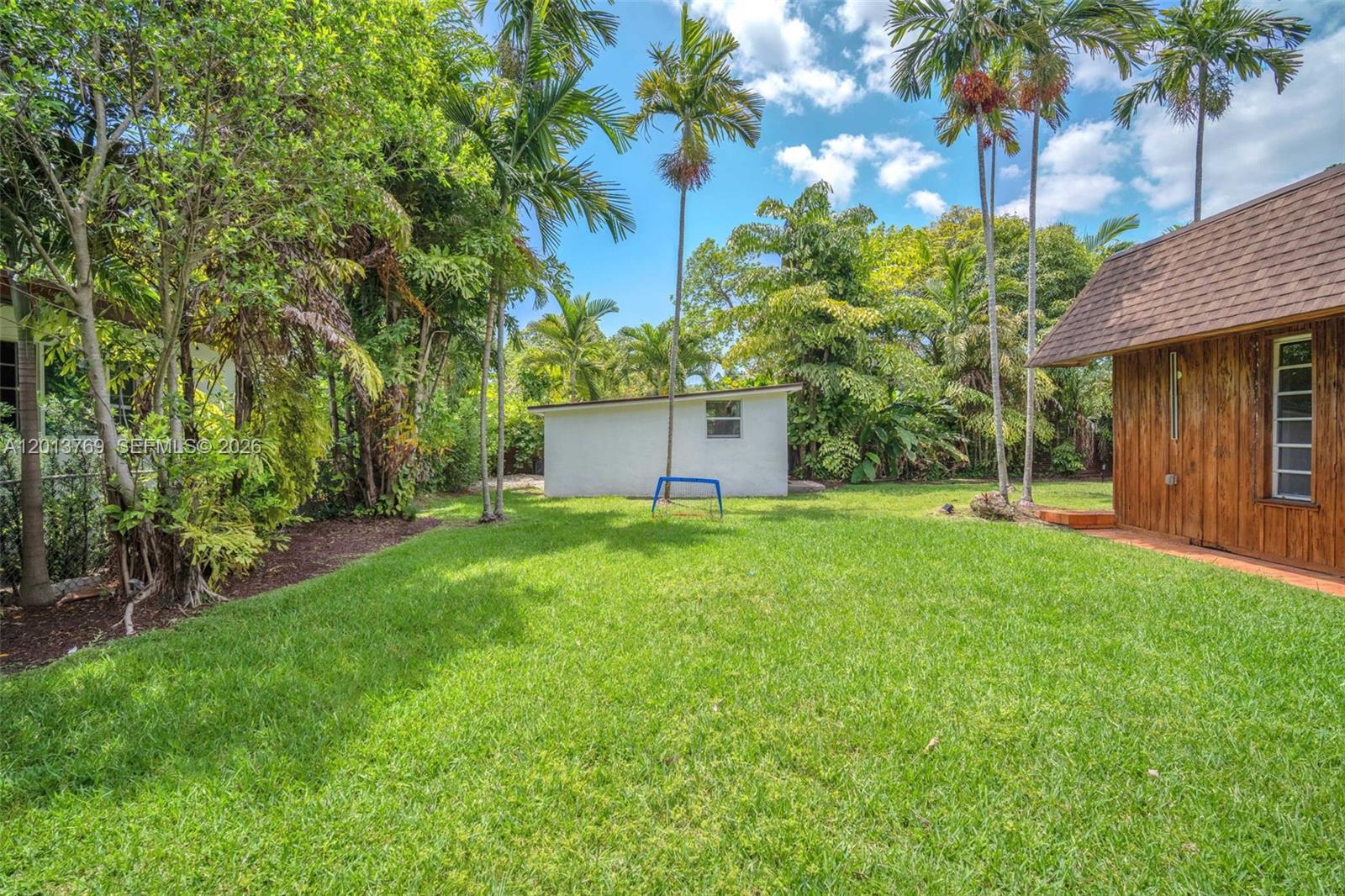 470 Northeast 113th Street, Unit 1 Miami, FL 33161 - Photo 51 of 56 a backyard of a house with lots of green space