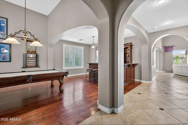 a view of a hallway with windows and chandelier