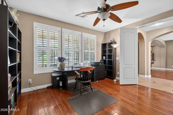 a view of a hallway to dining room with wooden floor