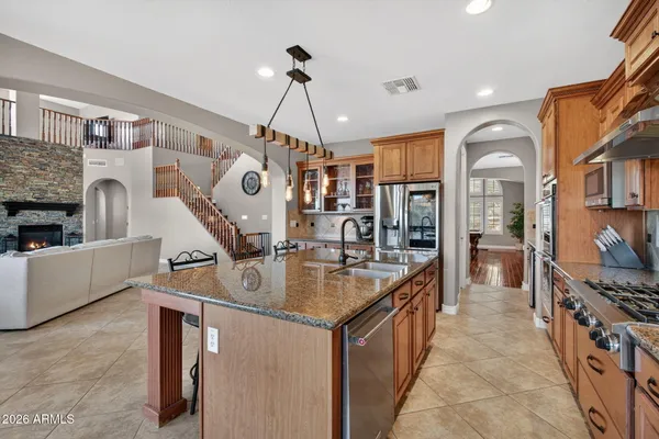 a kitchen with stainless steel appliances granite countertop a stove and a sink