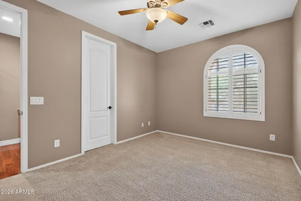 a bathroom with a granite countertop double vanity sink and a mirror
