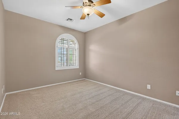 a spacious bathroom with a tub sink and mirror