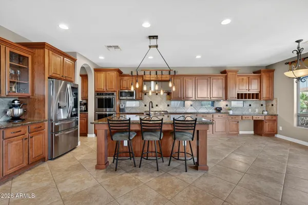 a room with wooden floor pool table and windows