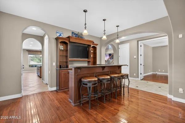 a spacious bathroom with a granite countertop sink a mirror and shower