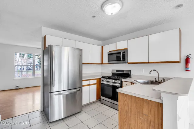a kitchen with stainless steel appliances a stove a microwave and cabinets