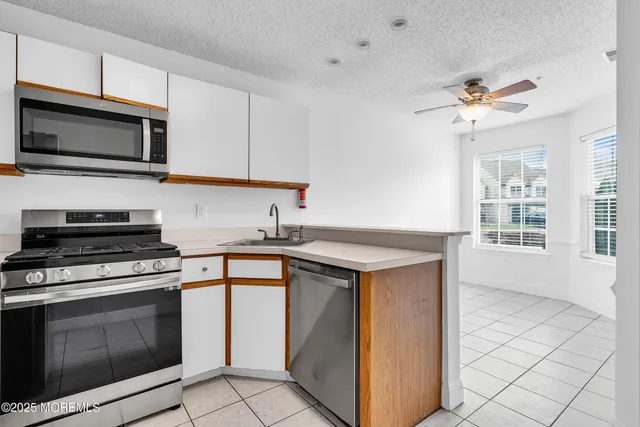 a kitchen with stainless steel appliances granite countertop a sink and a stove