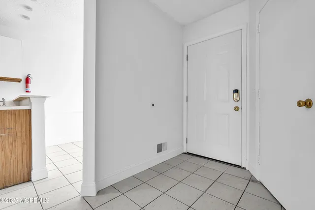 a view of a kitchen with a refrigerator and a stove top oven