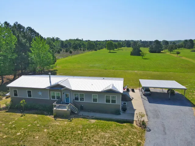 an aerial view of a house having swimming pool garden and patio