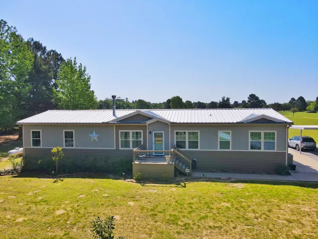 a front view of a house with swimming pool and porch
