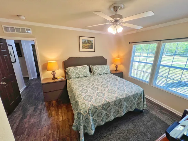 a bedroom with a bed and a chandelier