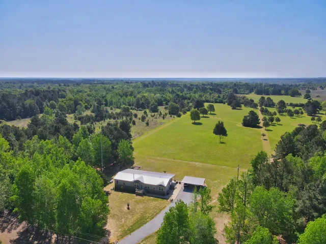 an aerial view of a house with a yard