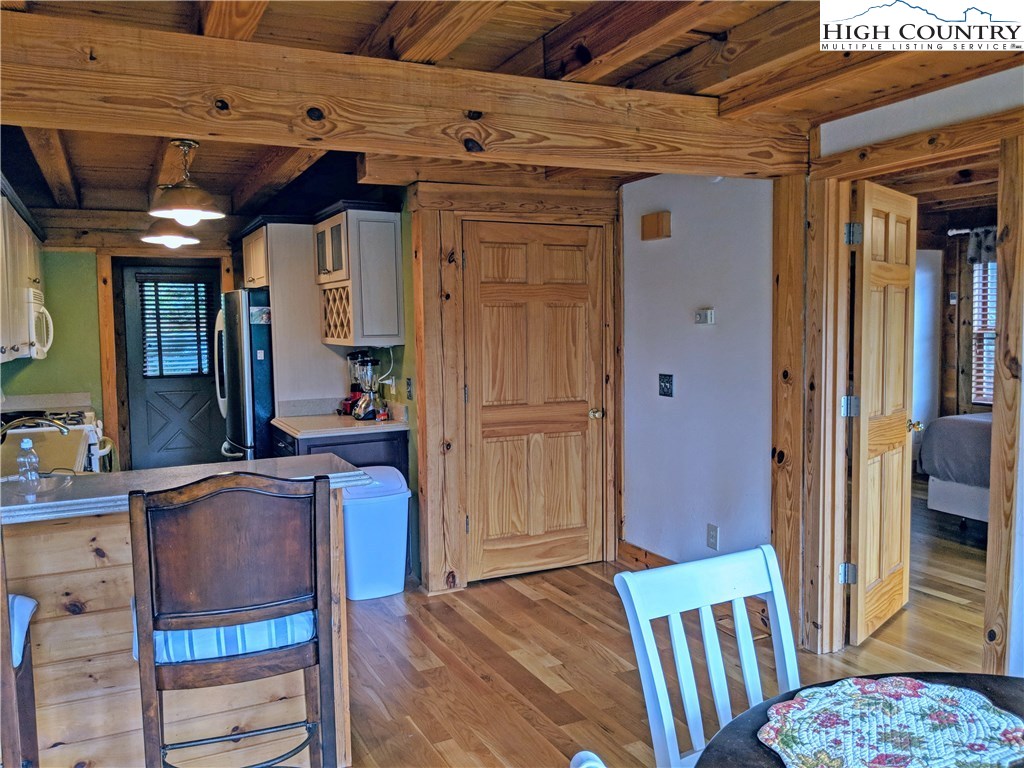 375 Deer Run Road Deep Gap, NC 28618 - Photo 11 of 44 a view of a hallway with wooden floor and staircase