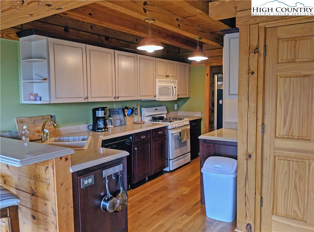 375 Deer Run Road Deep Gap, NC 28618 - Photo 12 of 44 a kitchen with stainless steel appliances granite countertop a sink a stove and a refrigerator