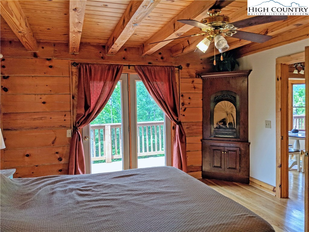 375 Deer Run Road Deep Gap, NC 28618 - Photo 13 of 44 a bedroom with a bed closet and flat tv screen