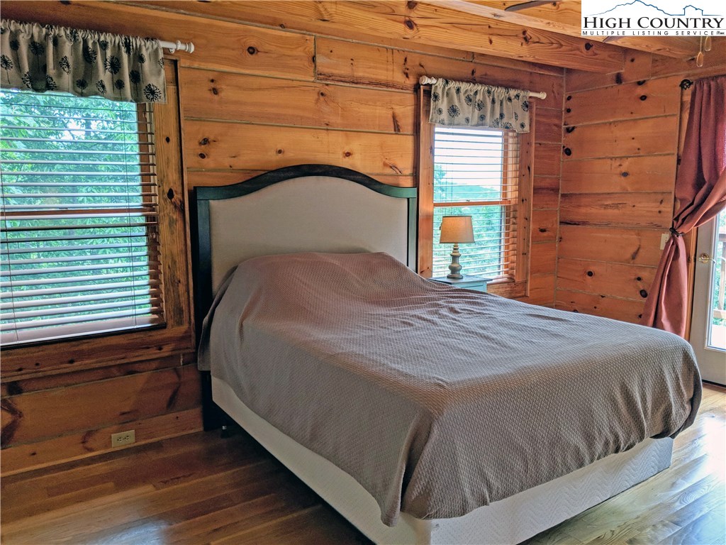 375 Deer Run Road Deep Gap, NC 28618 - Photo 15 of 44 a bed sitting in a bedroom next to a window