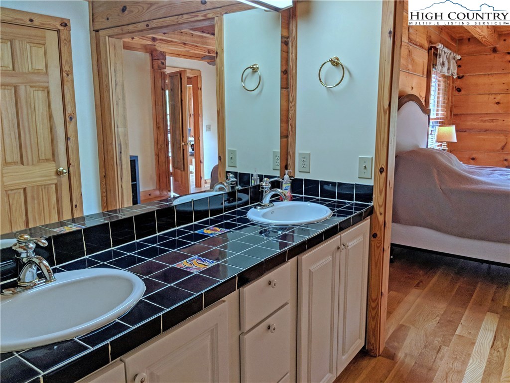 375 Deer Run Road Deep Gap, NC 28618 - Photo 16 of 44 a bathroom with a granite countertop sink and a mirror