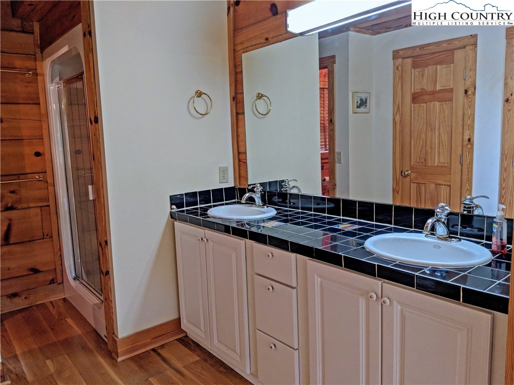 375 Deer Run Road Deep Gap, NC 28618 - Photo 17 of 44 a bathroom with a granite countertop sink and a mirror