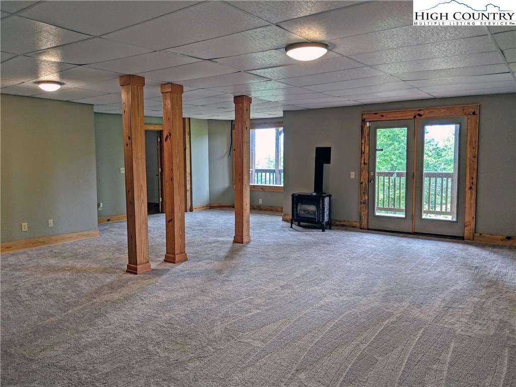 375 Deer Run Road Deep Gap, NC 28618 - Photo 30 of 44 a view of an empty room with a fireplace and a window