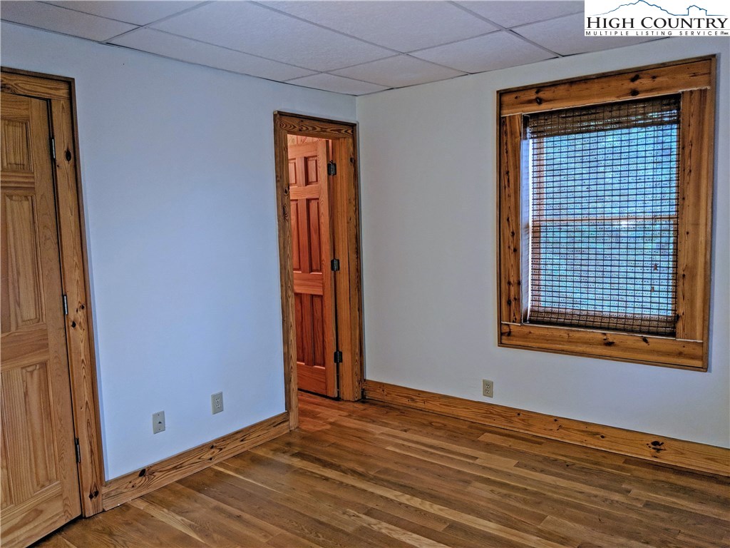 375 Deer Run Road Deep Gap, NC 28618 - Photo 31 of 44 a view of an empty room with wooden floor and a window