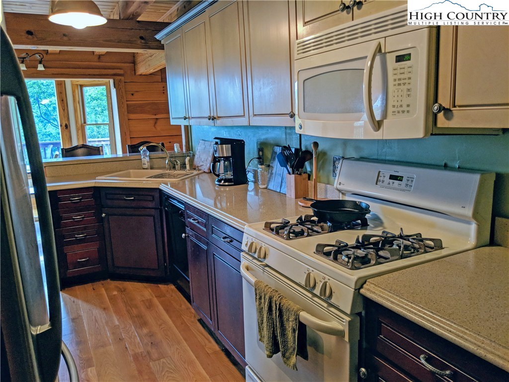 375 Deer Run Road Deep Gap, NC 28618 - Photo 6 of 44 a kitchen with stainless steel appliances granite countertop a stove and a refrigerator