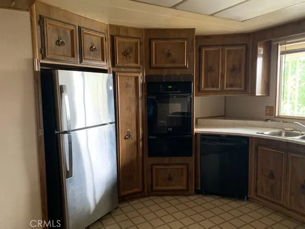 a kitchen with a refrigerator and a sink
