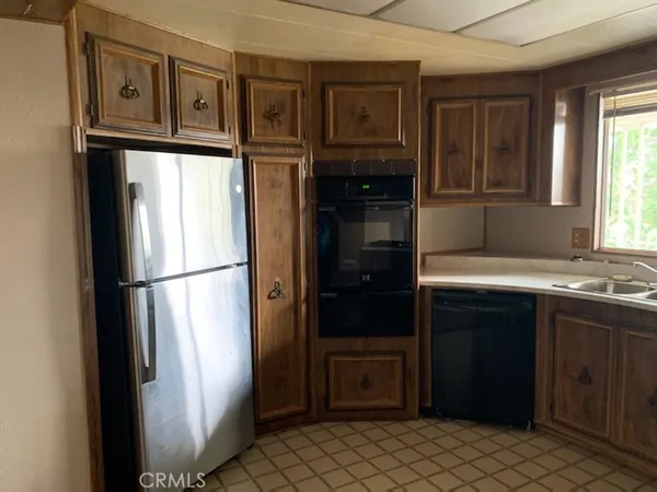 a kitchen with a refrigerator and a sink