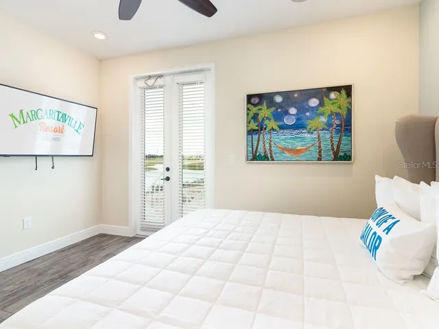 a bedroom with a bed and a painting on the wall