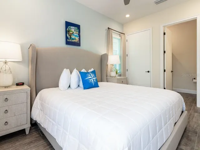 a bedroom with a bed and a painting on the wall