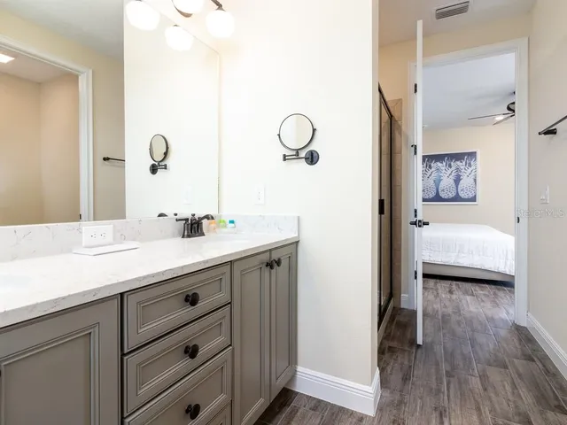 a bedroom with a bed and painting on the wall