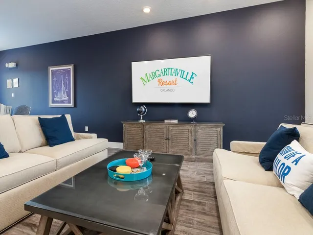 a living room with furniture and a flat screen tv